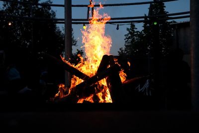 Bonfire on wooden structure at night