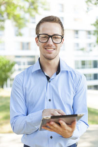 Portrait of young man using smart phone