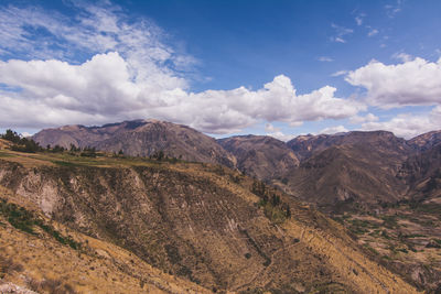 Scenic view of mountains against cloudy sky