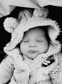 Close-up of cute baby boy sleeping at home