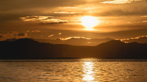 Scenic view of lake against sky during sunset