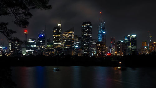 Beautiful sydney harbor with office buildings light and illumination at night.