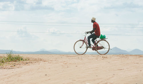 Man riding bicycle on road
