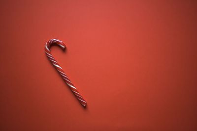 High angle view of metal on table against red background