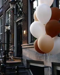 Low angle view of balloons hanging outside house