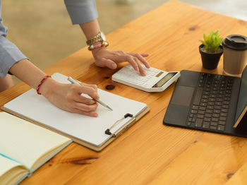 High angle view of woman using laptop on table