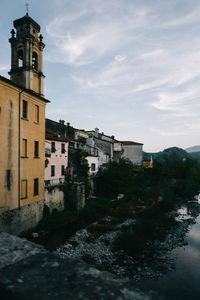 River by trees against sky