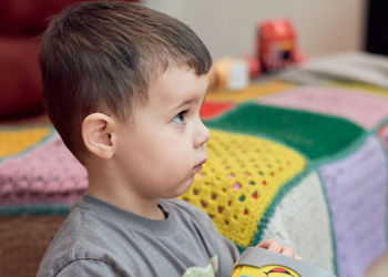 Expressive young boy watching cartoons in the livingroom