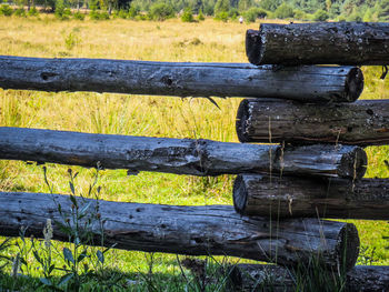 Close-up of old wooden bench on field