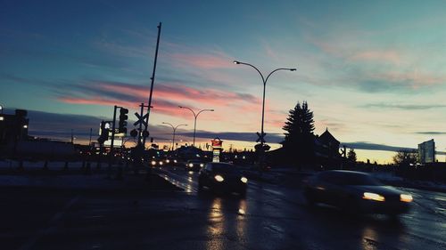 Traffic on road at sunset