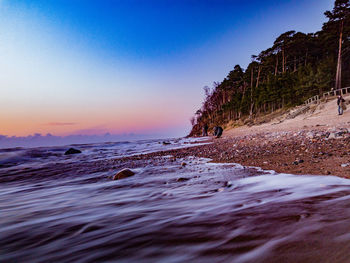 Scenic view of sea against clear sky during sunset