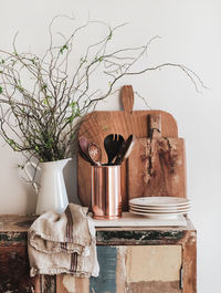 Kitchen utensils, chopping boards and plates on rustic counter