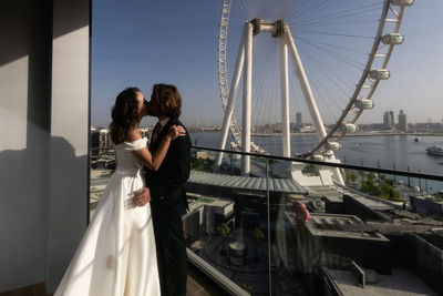 Rear view of woman standing on bridge