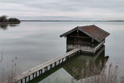 Scenic view at a boathouse on the mirrorlike chiemsee, bavarian  alpine lake 