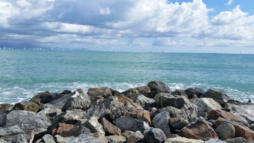Scenic view of sea against cloudy sky