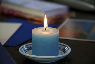 Close-up of illuminated candles on table