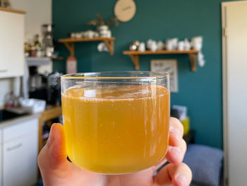 Close-up of hand holding drink in glass