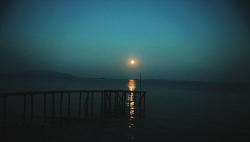 Scenic view of sea against clear sky at night