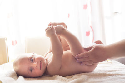 Portrait of woman lying on bed