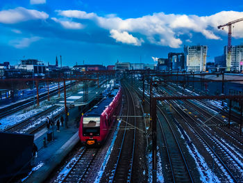 High angle view of railroad tracks in city against sky during dusk