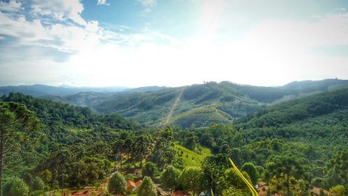 Scenic view of green landscape against sky