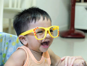 Smiling boy wearing eyeglasses at home