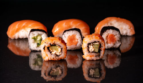 Close-up of sushi against black background