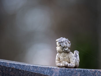 Close-up of small statue against blurred background