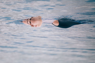 Young woman swimming in pool