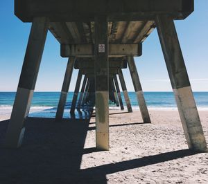 Low angle view of pier at beach