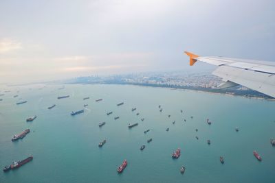 High angle view of sailboats in sea against sky