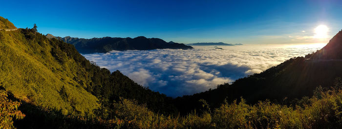 Scenic view of sea and silhouette mountains against sky