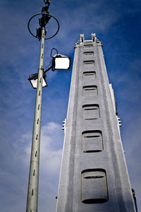 Low angle view of street light against blue sky