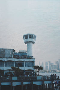 Modern buildings by swimming pool in city against sky