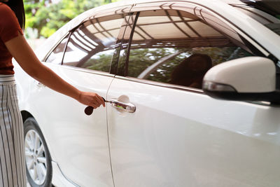 Car unlocks, woman use key to open the car door