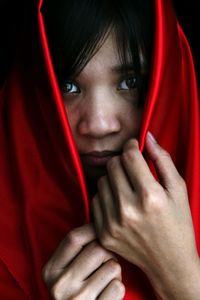 Close-up of woman holding red hair