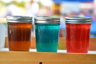 Row of glass jars of colorful artisanal jelly in glass jars at farmer's market