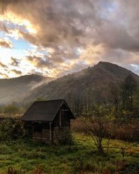 Built structure on field against sky during sunset