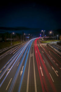 High angle view of light trails on highway at night