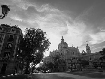 Street amidst buildings against sky in city