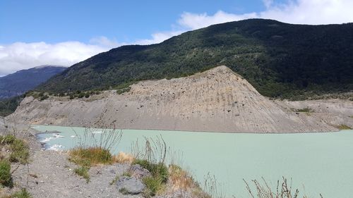 High angle view of lake and mountains against sky