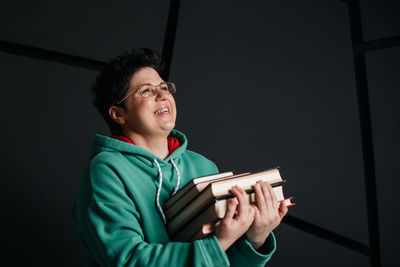 Smiling young man holding book