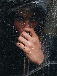 Close-up of wet woman over black background