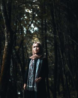 Young woman wearing hijab in forest