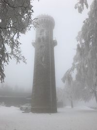 Statue by trees against sky