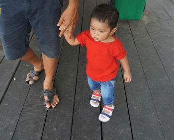 High angle view of father and son standing on floor