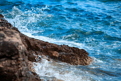 Waves splashing on rocks at shore