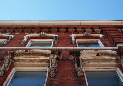 Looking up at the top of old brick buildings
