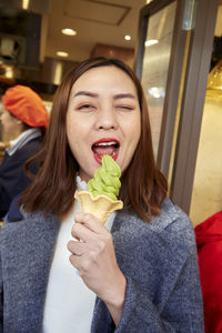 Portrait of young woman eating food