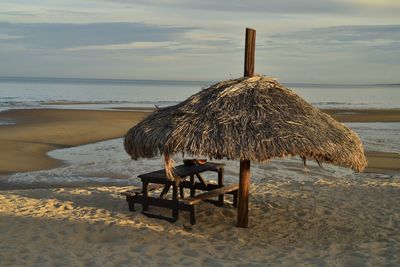 Watermelon picnic under a palm thatched beach umbrella sea of cortez, san felipe, baja, mexico